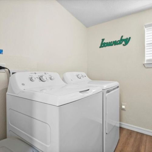Walk-in Laundry room with washer and dryer.